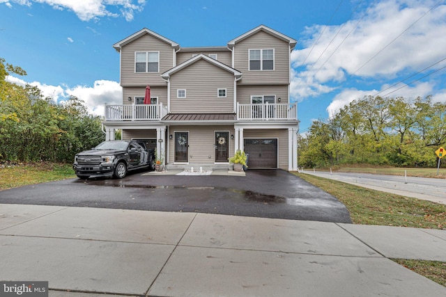 view of front of home with a garage and a balcony