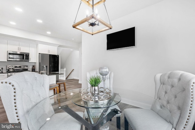 dining room featuring light wood finished floors, recessed lighting, and baseboards