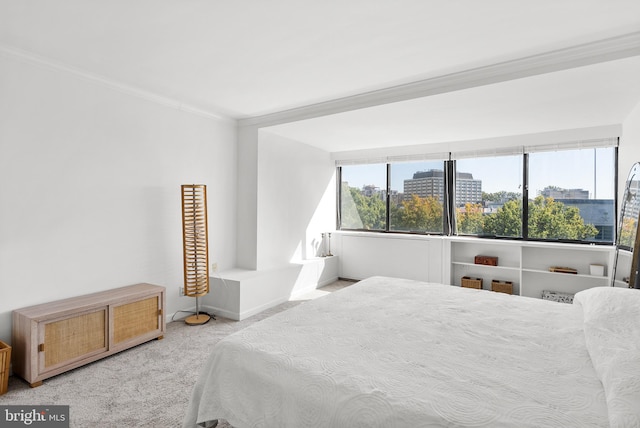 bedroom featuring multiple windows, crown molding, and light colored carpet