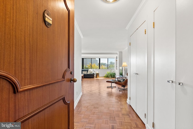 hall with ornamental molding and light parquet flooring