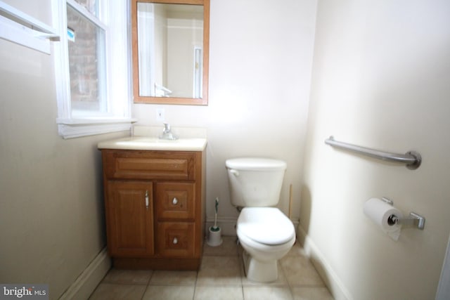 bathroom with vanity, toilet, and tile patterned floors