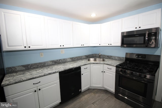 kitchen with white cabinetry, sink, dark wood-type flooring, and stainless steel appliances