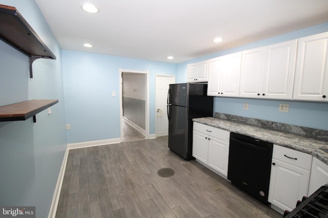 kitchen featuring white cabinets, black appliances, and wood-type flooring