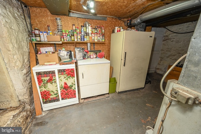 basement with washer / dryer and white fridge