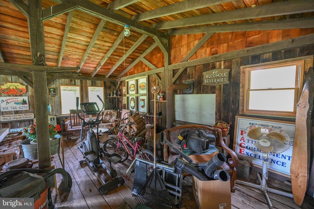 misc room with wood ceiling, hardwood / wood-style flooring, lofted ceiling with beams, and wood walls