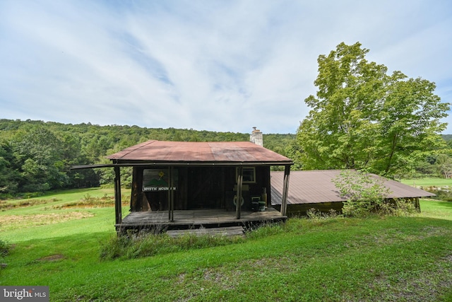 rear view of property featuring a yard