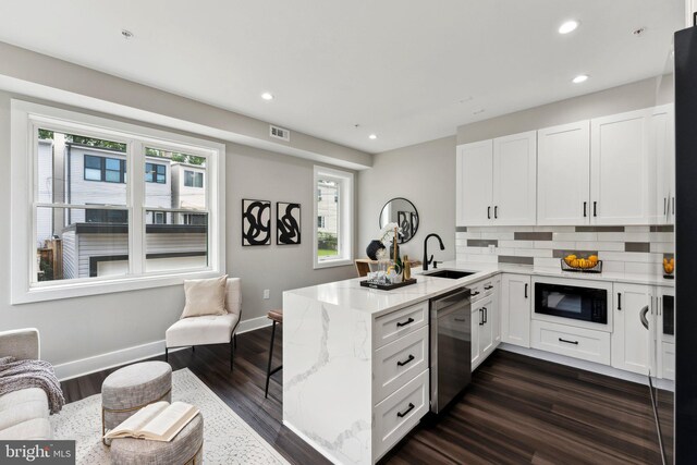 kitchen with sink, kitchen peninsula, stainless steel dishwasher, white cabinetry, and black microwave