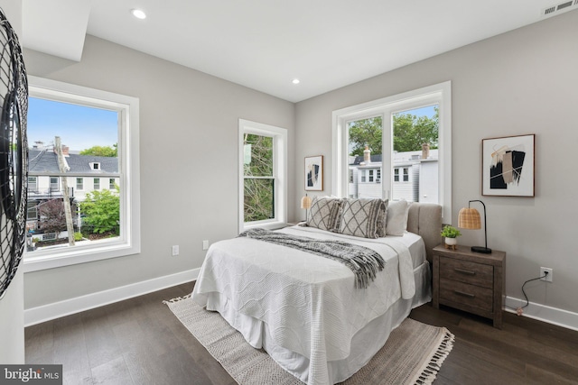 bedroom with dark hardwood / wood-style floors