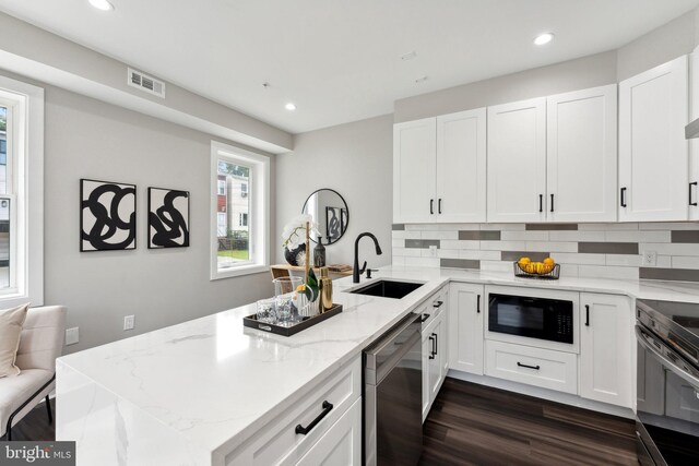 kitchen with sink, white cabinetry, dishwasher, dark hardwood / wood-style floors, and black microwave