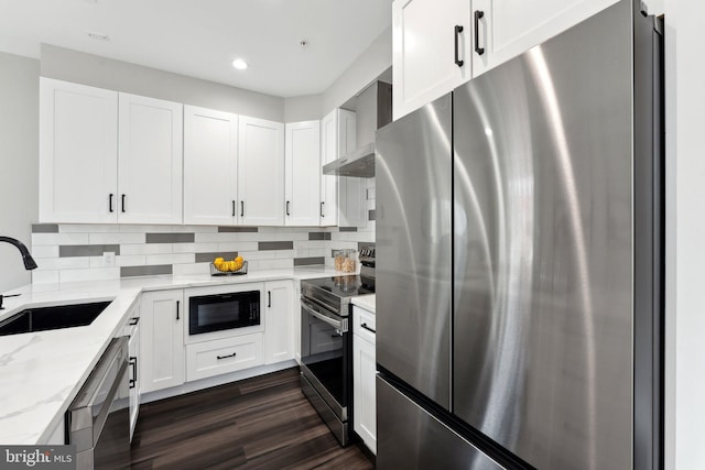 kitchen featuring stainless steel appliances, white cabinets, dark hardwood / wood-style floors, and sink