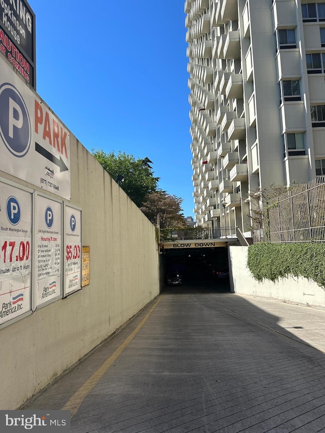 exterior space with fence and a parking lot