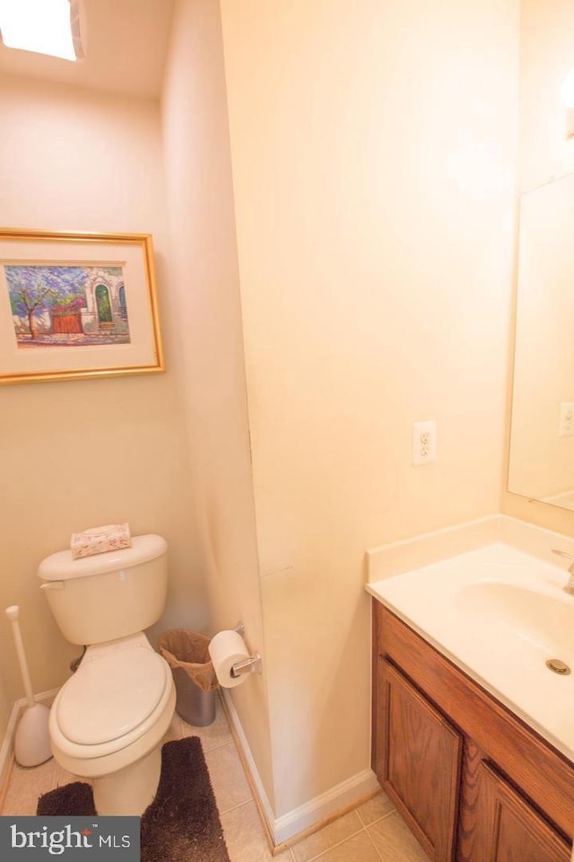 bathroom featuring vanity, toilet, and tile patterned floors