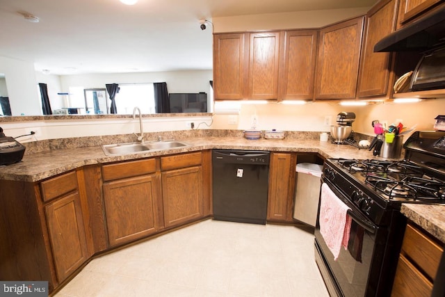 kitchen with black appliances, sink, and exhaust hood