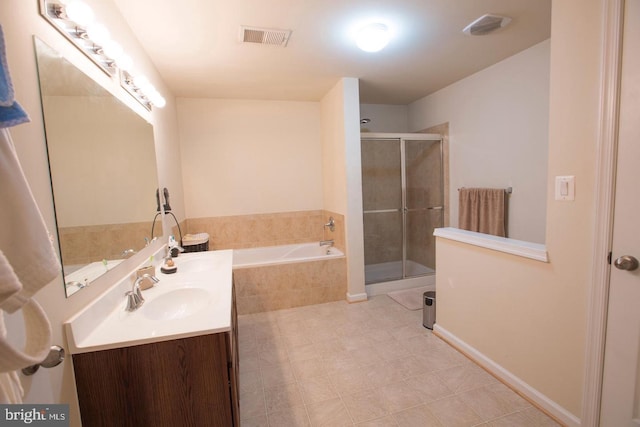 bathroom with vanity and separate shower and tub