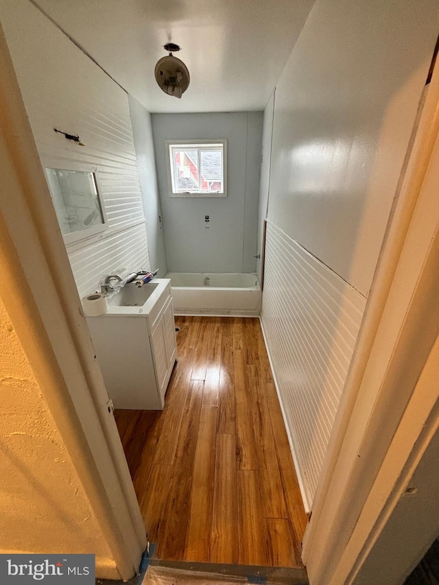 hall featuring sink and light hardwood / wood-style flooring