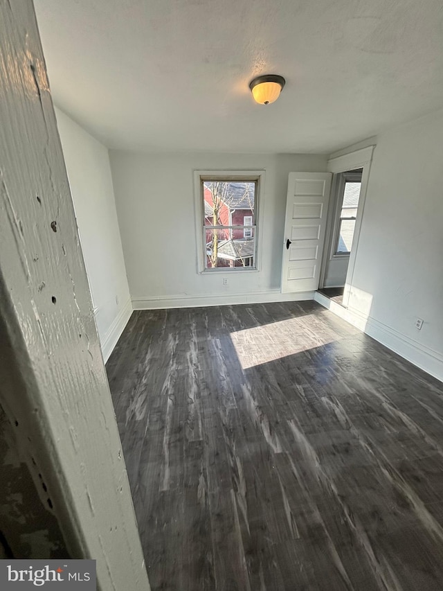 unfurnished room featuring dark hardwood / wood-style flooring