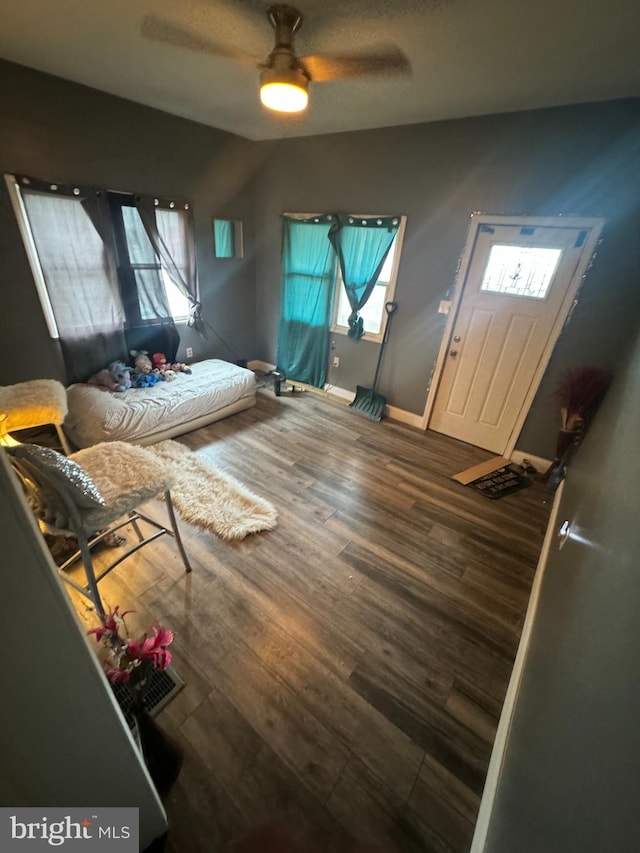 bedroom featuring ceiling fan and dark hardwood / wood-style flooring