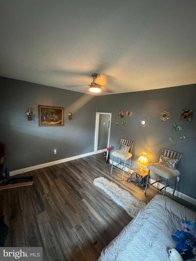 sitting room featuring hardwood / wood-style floors and ceiling fan