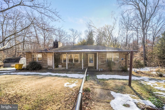 ranch-style house featuring a shed and a front yard