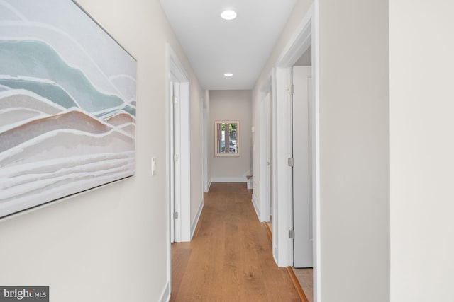 hallway with light hardwood / wood-style floors