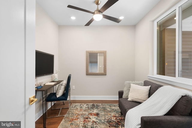 home office with ceiling fan and dark hardwood / wood-style floors