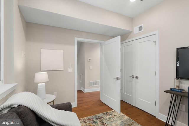 bedroom featuring wood-type flooring and a closet