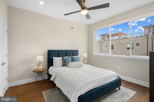 bedroom with ceiling fan and dark wood-type flooring