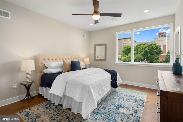 bedroom with ceiling fan and hardwood / wood-style flooring