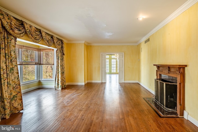 unfurnished living room with crown molding and hardwood / wood-style floors