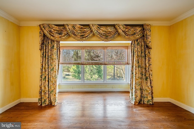 unfurnished living room with crown molding and hardwood / wood-style floors