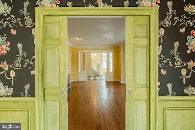 doorway to outside with hardwood / wood-style floors and crown molding