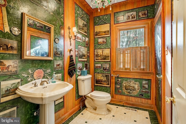 bathroom with a chandelier and toilet