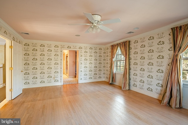 unfurnished room with ceiling fan, light hardwood / wood-style floors, and ornamental molding