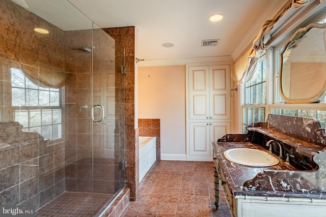 bathroom with vanity and independent shower and bath