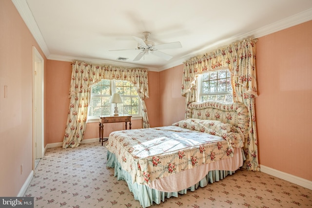 carpeted bedroom featuring ceiling fan and crown molding