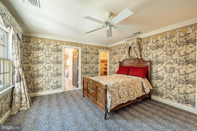 bedroom with carpet floors, ensuite bathroom, ceiling fan, and crown molding