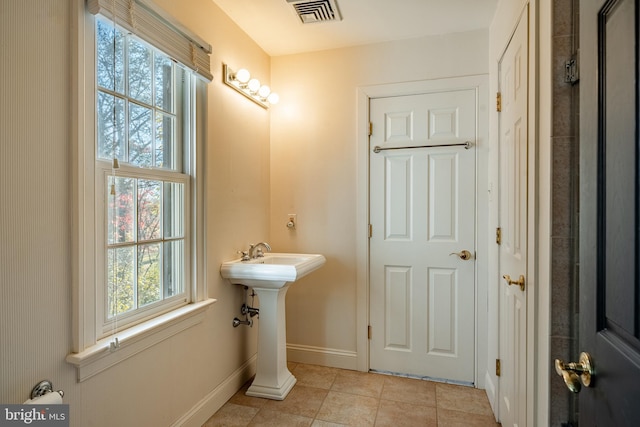 bathroom with tile patterned floors and a wealth of natural light