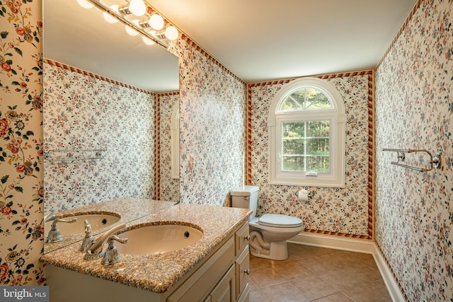 bathroom with tile patterned flooring, vanity, and toilet