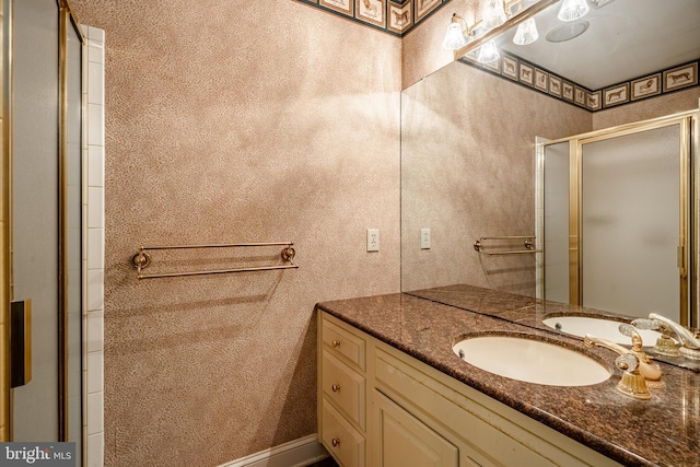 bathroom with vanity and a shower with door