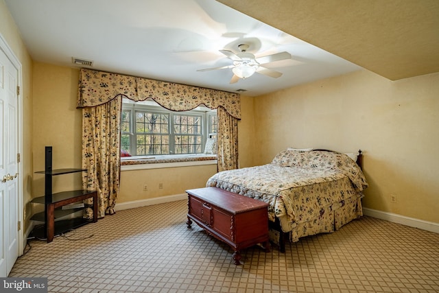 bedroom featuring ceiling fan and light carpet