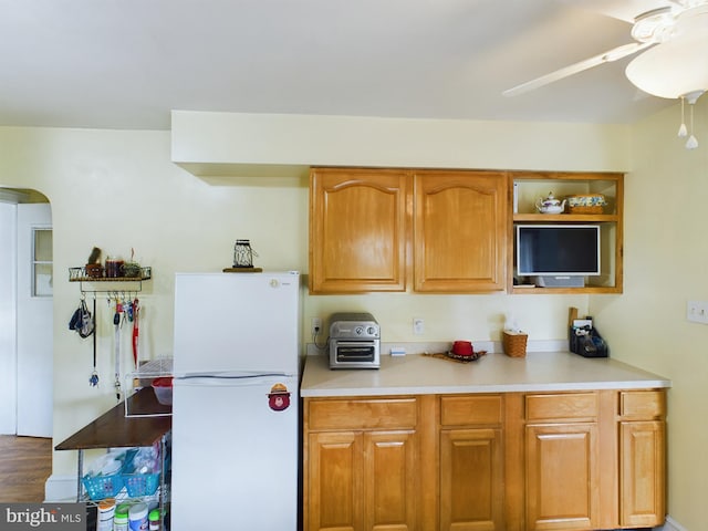 kitchen with ceiling fan, hardwood / wood-style flooring, and white fridge