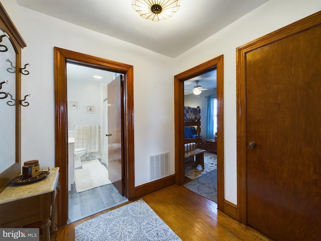 hall with hardwood / wood-style flooring