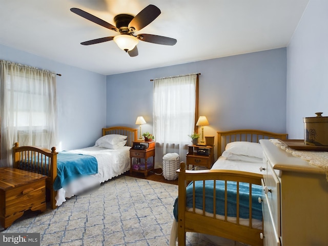 bedroom with light hardwood / wood-style floors and ceiling fan