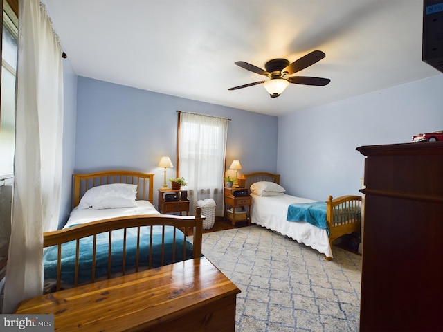 bedroom with light wood-type flooring and ceiling fan