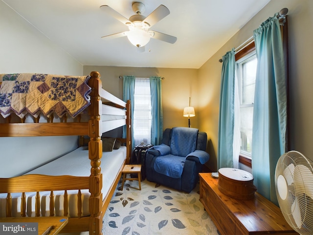 bedroom with multiple windows and ceiling fan