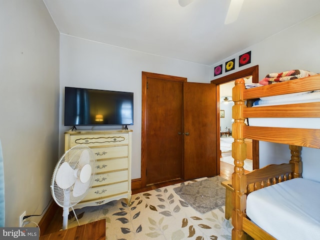 bedroom with light hardwood / wood-style flooring and ceiling fan