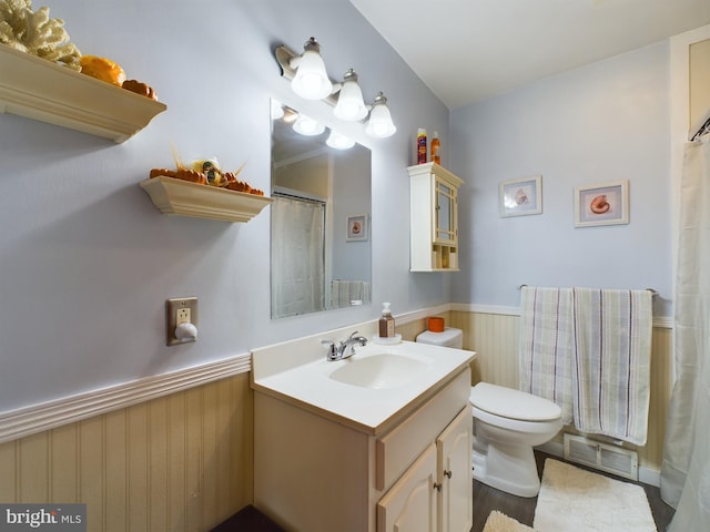 bathroom with vanity, toilet, and hardwood / wood-style flooring