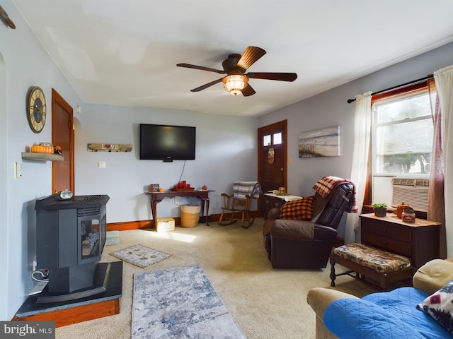 carpeted living room featuring ceiling fan and a wood stove