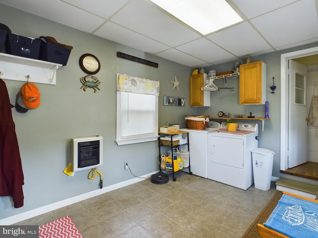 laundry area featuring cabinets, heating unit, light tile patterned floors, and washer and dryer