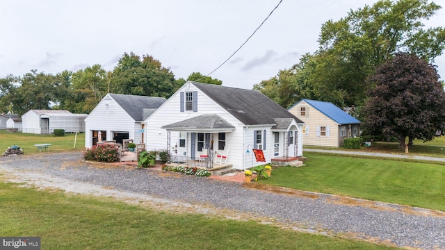 cape cod home with a front lawn and covered porch